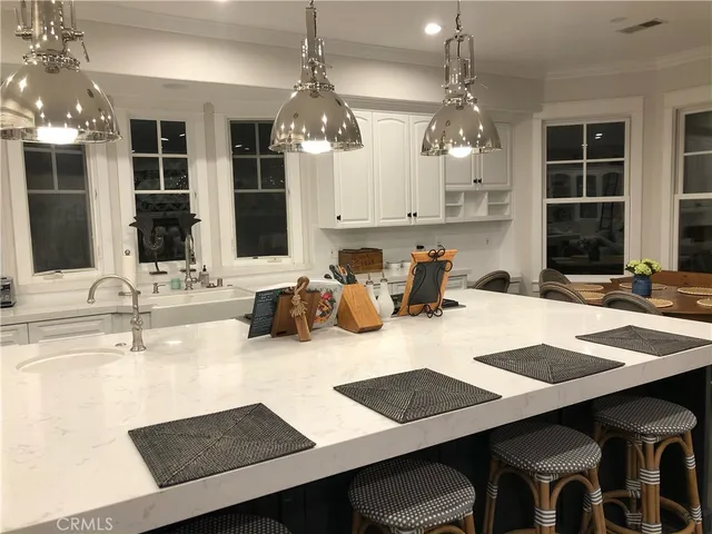 a kitchen with a dining table and chairs