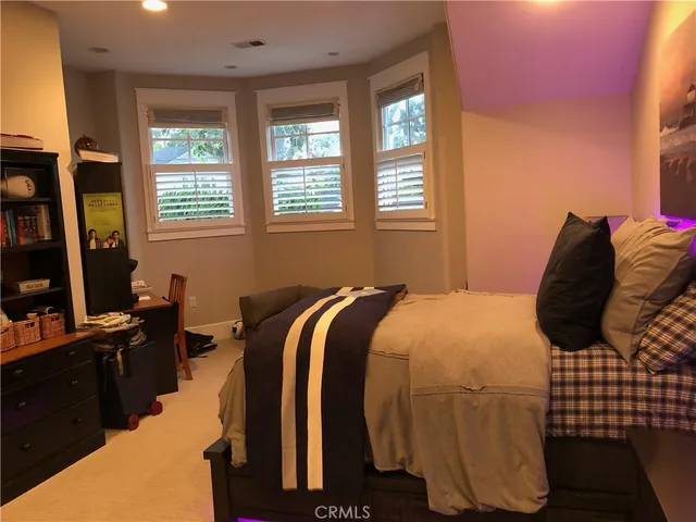 a bedroom with a bed and flat screen tv