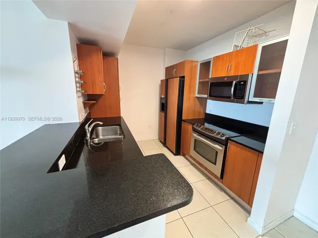 a view of a room with a sink and a refrigerator