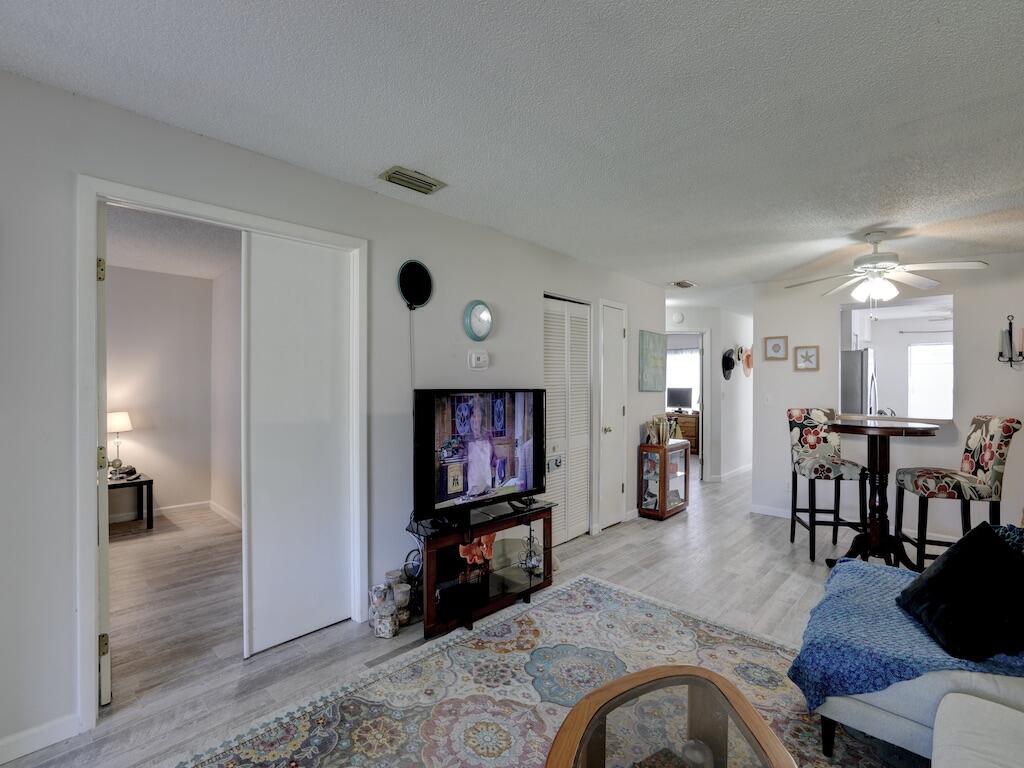 6022 Indrio Road, Unit 3 Fort Pierce, FL 34951 - Photo 12 of 35 a living room with furniture and a flat screen tv