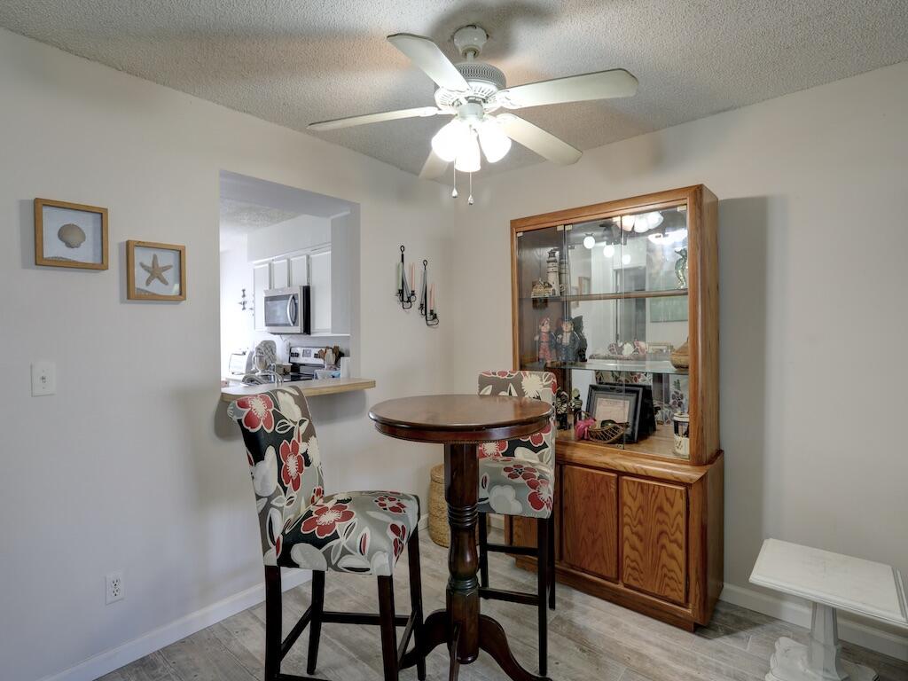 6022 Indrio Road, Unit 3 Fort Pierce, FL 34951 - Photo 13 of 35 a view of a dining room with furniture and chandelier