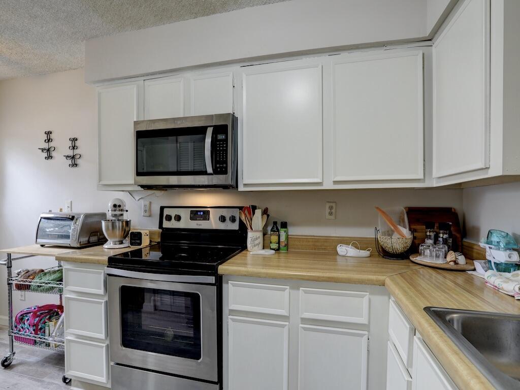 6022 Indrio Road, Unit 3 Fort Pierce, FL 34951 - Photo 17 of 35 a kitchen with a stove and a microwave