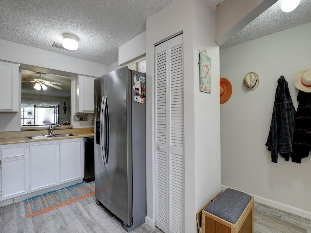 6022 Indrio Road, Unit 3 Fort Pierce, FL 34951 - Photo 19 of 35 a kitchen with stainless steel appliances granite countertop a refrigerator and a sink
