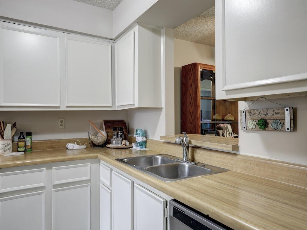 6022 Indrio Road, Unit 3 Fort Pierce, FL 34951 - Photo 20 of 35 a kitchen with stainless steel appliances granite countertop a sink and cabinets with wooden floor