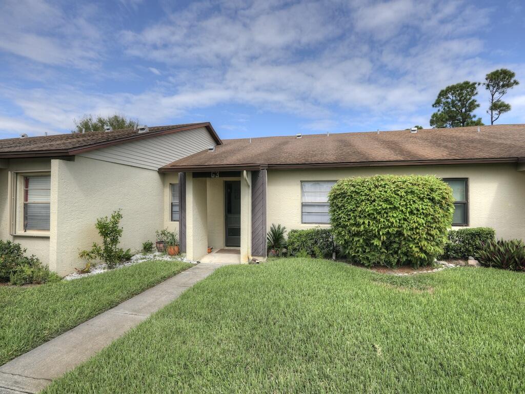 6022 Indrio Road, Unit 3 Fort Pierce, FL 34951 - Photo 2 of 35 a view of a house with a yard