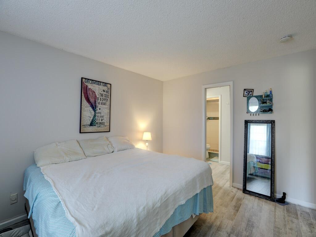 6022 Indrio Road, Unit 3 Fort Pierce, FL 34951 - Photo 22 of 35 a bedroom with a bed and painting on the wall