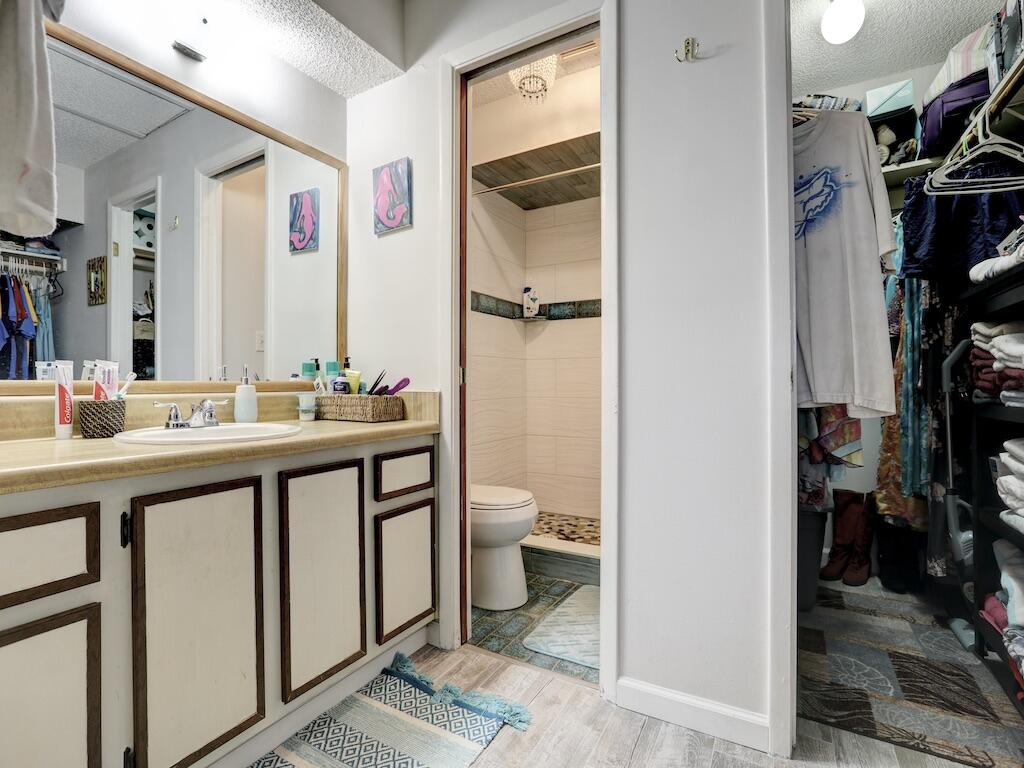 6022 Indrio Road, Unit 3 Fort Pierce, FL 34951 - Photo 24 of 35 a bathroom with a double vanity sink toilet and shower