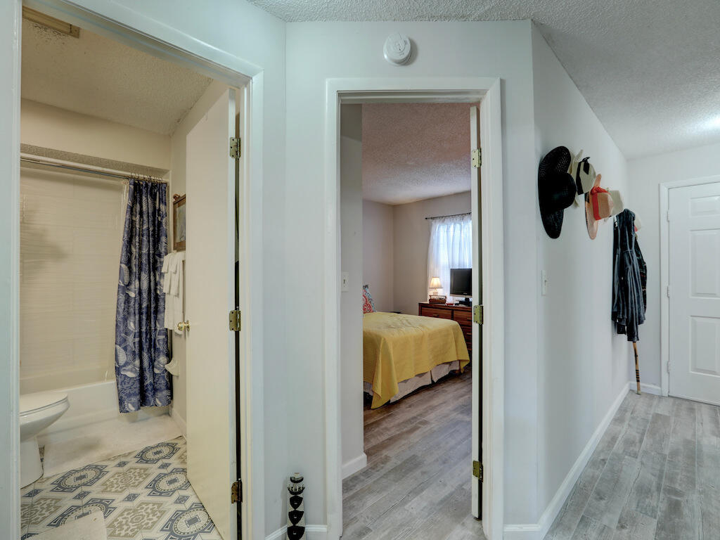 6022 Indrio Road, Unit 3 Fort Pierce, FL 34951 - Photo 26 of 35 a bedroom with a bed and a mirror