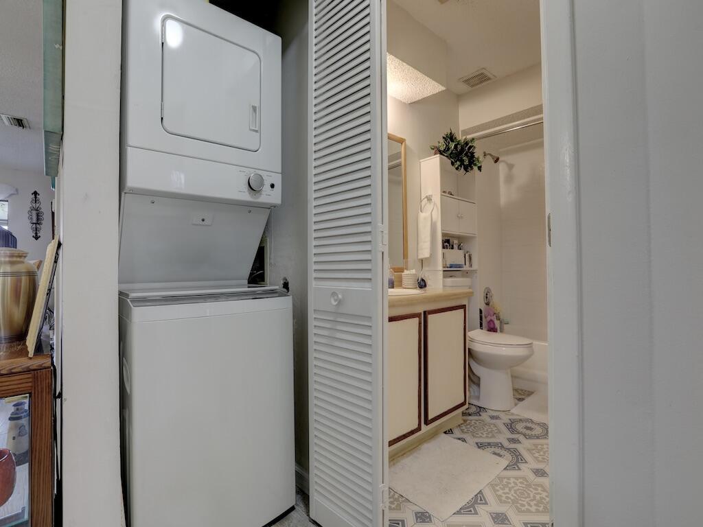 6022 Indrio Road, Unit 3 Fort Pierce, FL 34951 - Photo 30 of 35 a bathroom with a toilet a sink and a mirror
