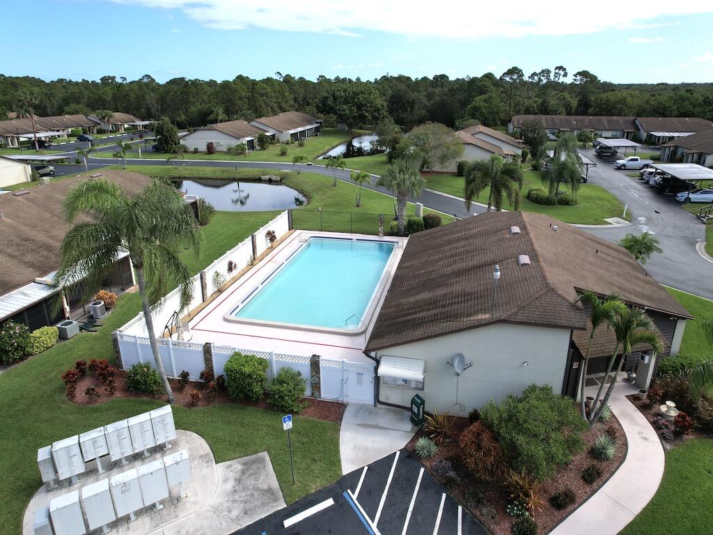 6022 Indrio Road, Unit 3 Fort Pierce, FL 34951 - Photo 32 of 35 an aerial view of a house with pool big yard and outdoor seating