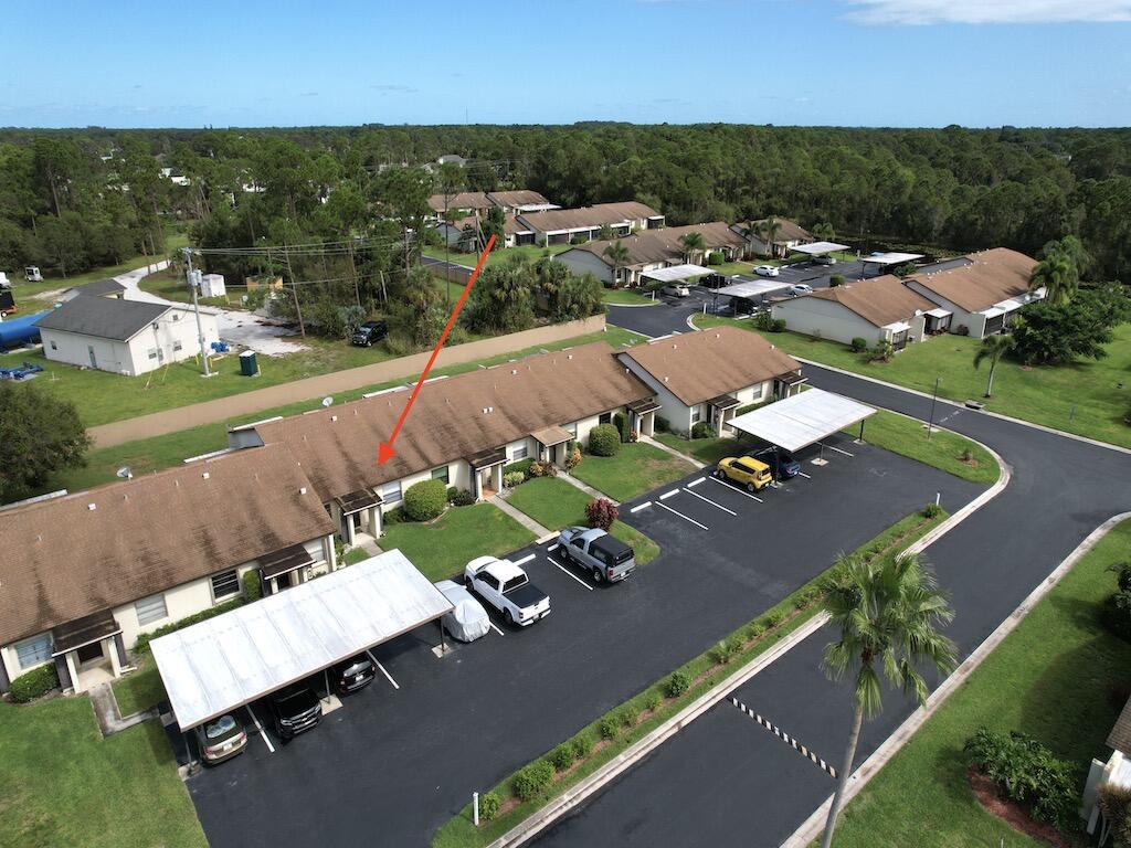 6022 Indrio Road, Unit 3 Fort Pierce, FL 34951 - Photo 5 of 35 an aerial view of a house with a garden