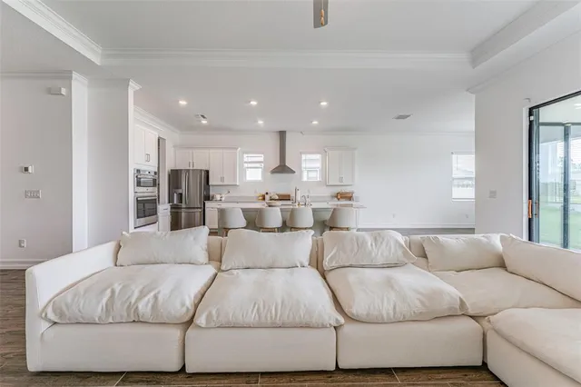 a living room with furniture and kitchen view