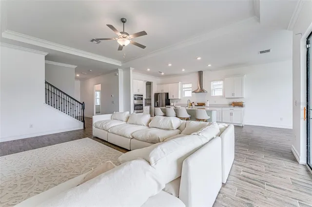a living room with furniture and kitchen view