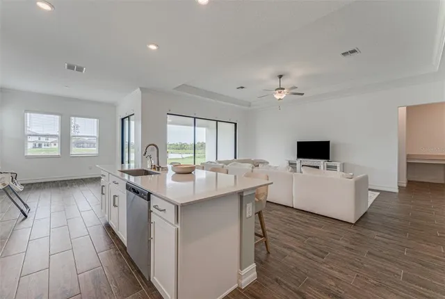 a kitchen with a stove and a wooden floor