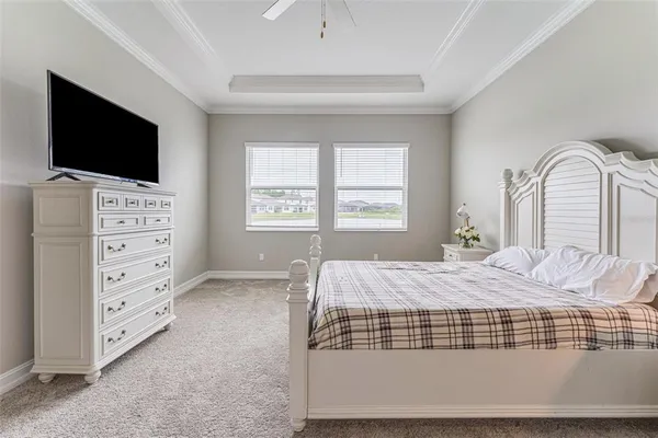 a bedroom with a bed and flat screen tv