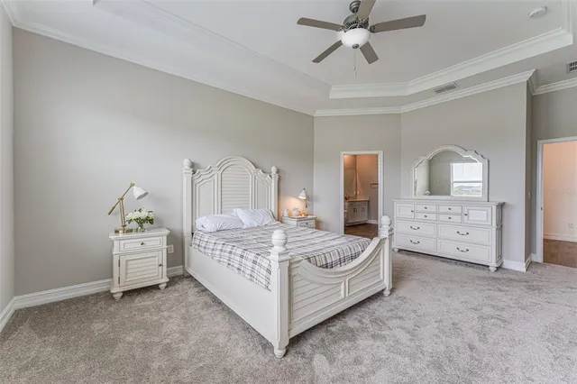 a bedroom with a bed and ceiling chandelier