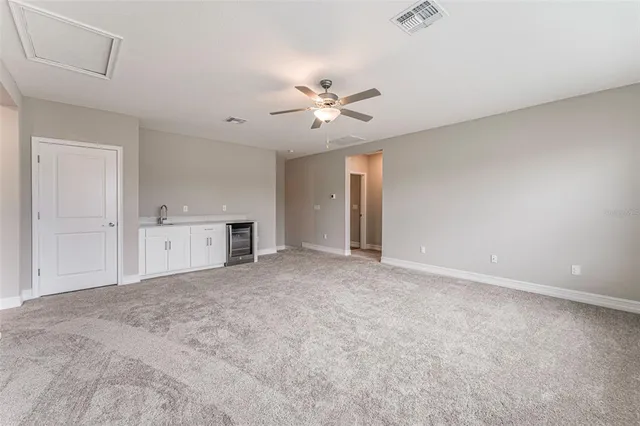 a view of empty room with a ceiling fan and a window