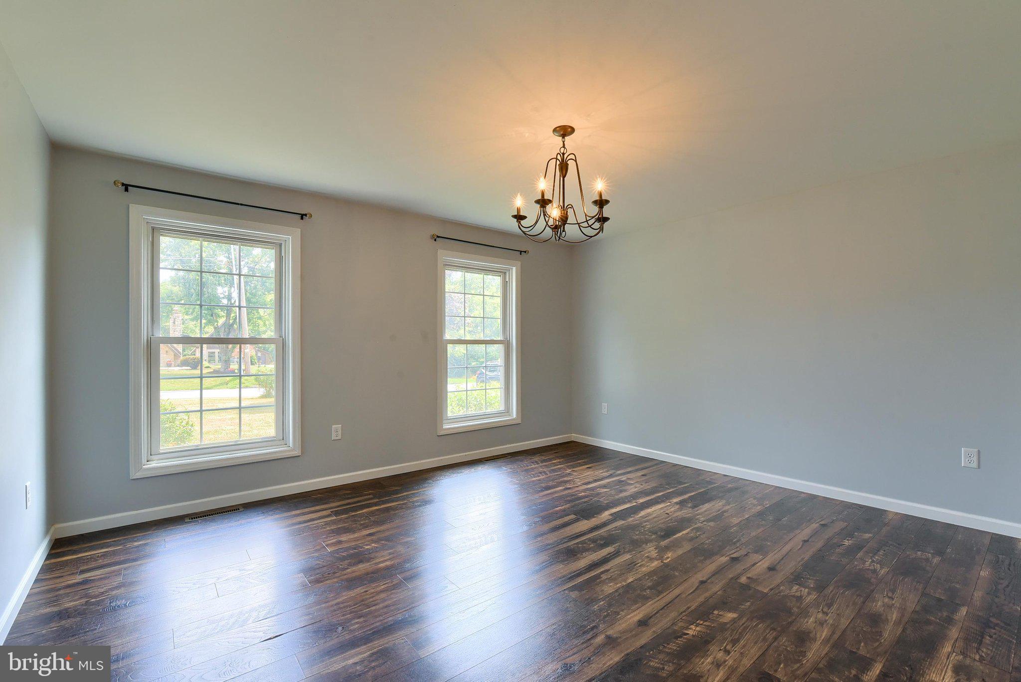 3740 Beagle Road Middletown, PA 17057 - Photo 13 of 70 an empty room with wooden floor chandelier and windows