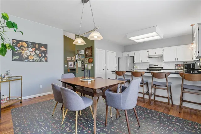 a view of a dining room with furniture and wooden floor
