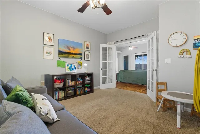 a bedroom with furniture and a fan