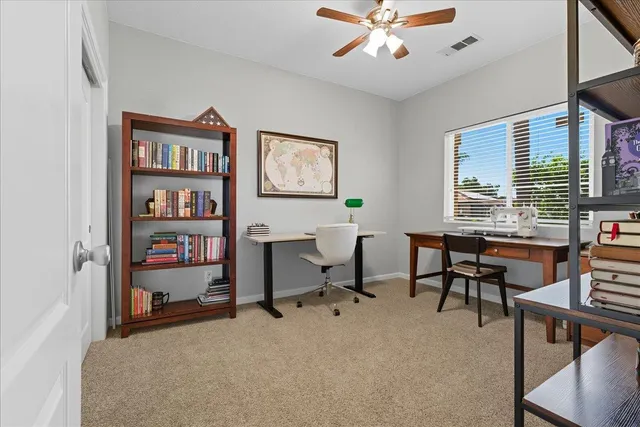 a view of a livingroom with workspace and a window