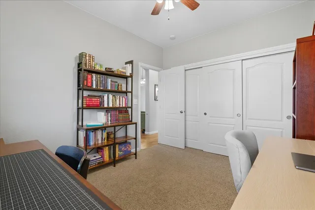a living room with furniture and a book shelf