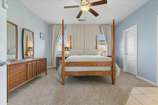 a spacious bedroom with a bed and a window