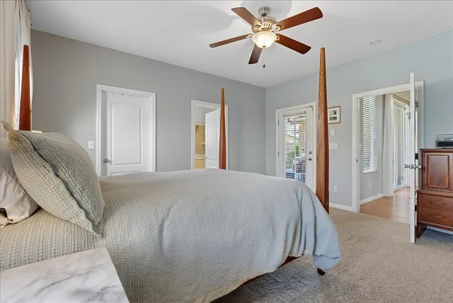 a spacious bedroom with a bed and a chandelier