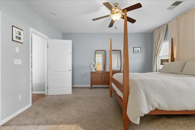 a spacious bedroom with a bed and a chandelier