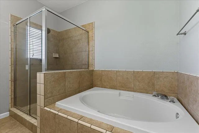 a bathroom with a bathtub and shower