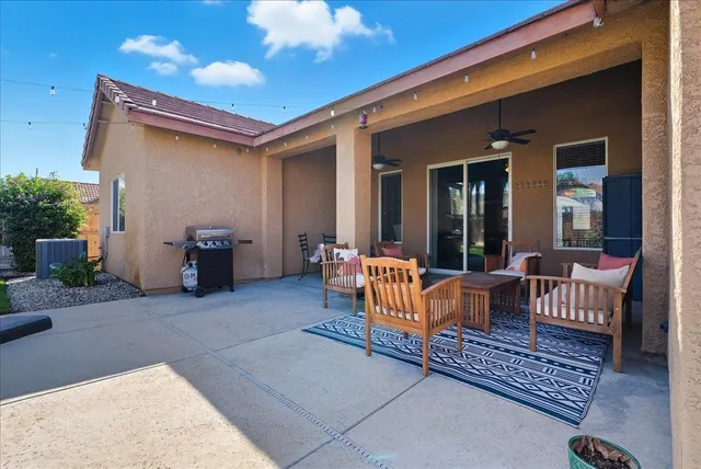 a balcony with furniture and a potted plant