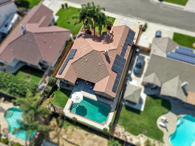 an aerial view of a house with garden space and furniture