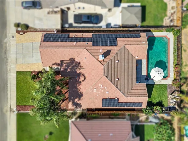 an aerial view of a house with a yard