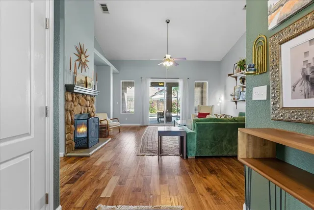 a living room with furniture and a wooden floor