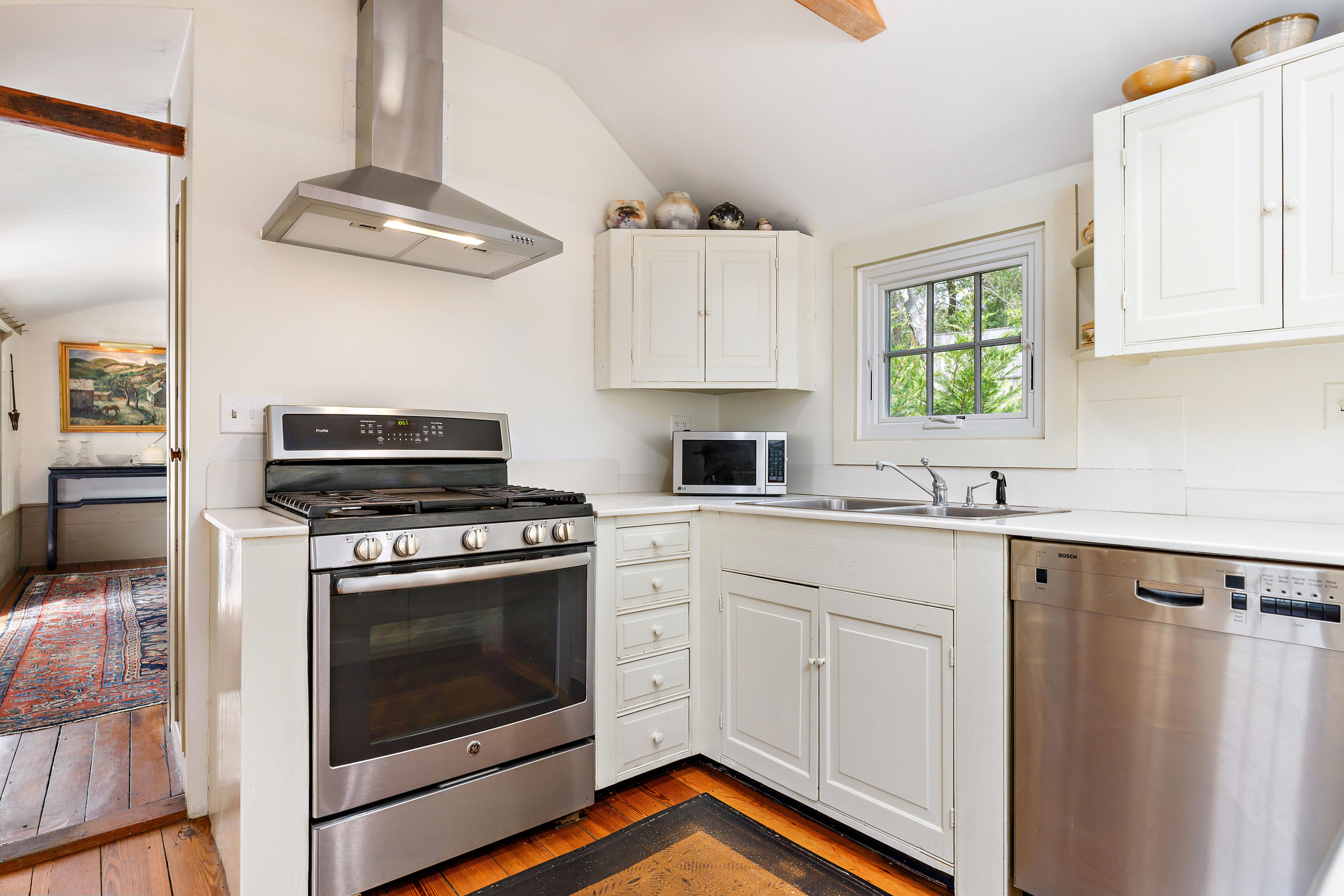 91 Castle Road Truro, MA 02666 - Photo 14 of 78 a kitchen with cabinets stainless steel appliances a sink and a stove