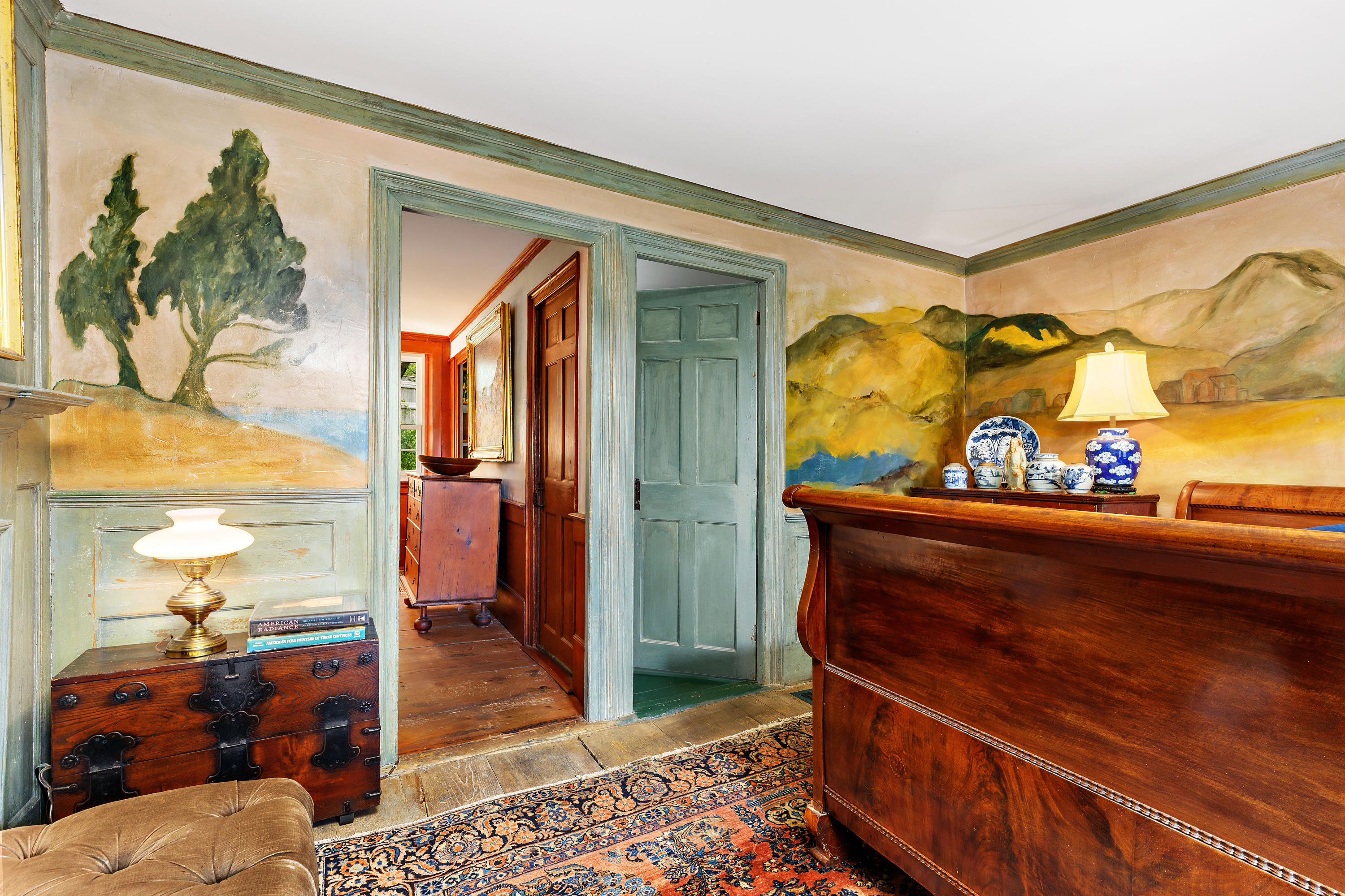91 Castle Road Truro, MA 02666 - Photo 28 of 78 a living room with blue wall painting and a potted plant