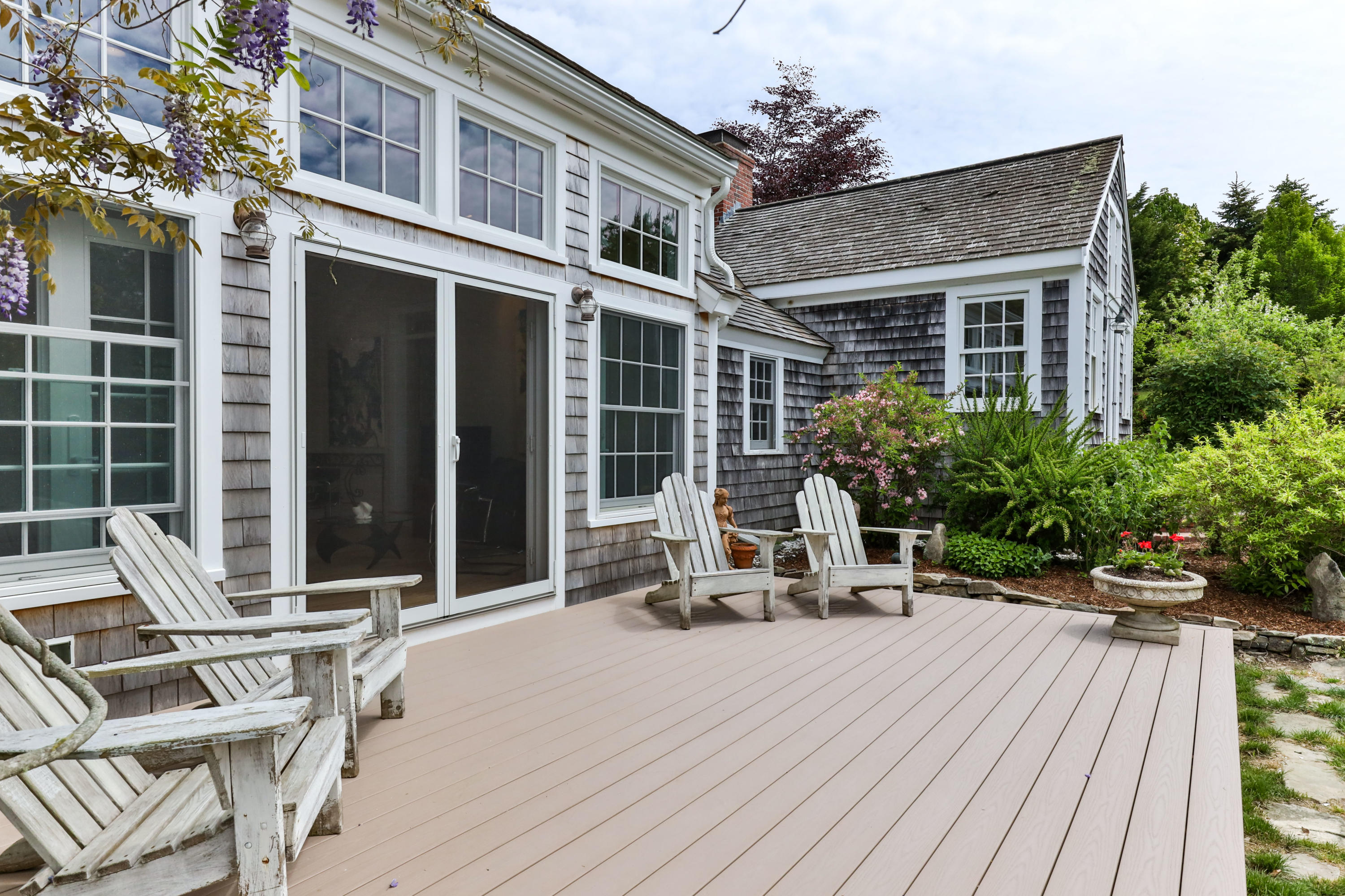 91 Castle Road Truro, MA 02666 - Photo 60 of 78 a view of a chair and tables in the patio of the house