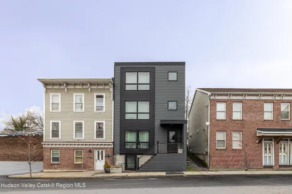 a front view of a residential apartment building with a yard