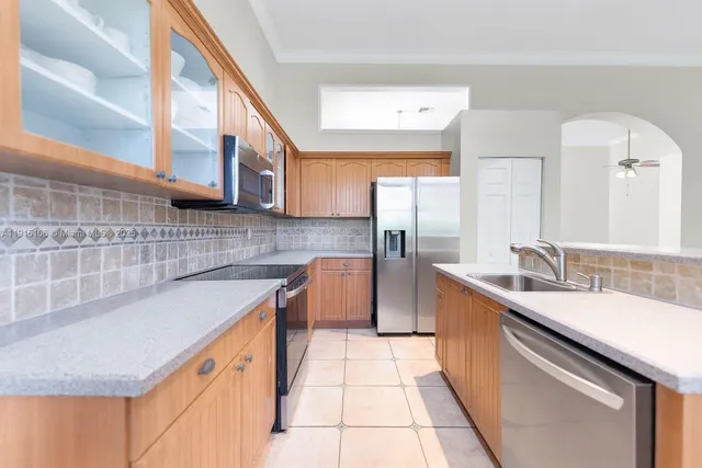 a kitchen with stainless steel appliances granite countertop a sink and cabinets