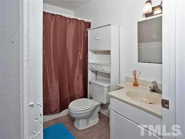 724 Godwin Court Raleigh, NC 27606 - Photo 3 of 8 a white toilet sitting next to a bathroom sink