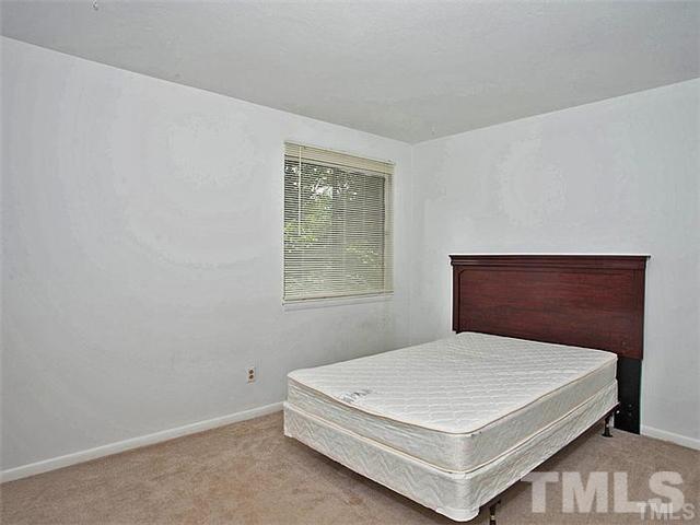 724 Godwin Court Raleigh, NC 27606 - Photo 5 of 8 a bedroom with a bed and window