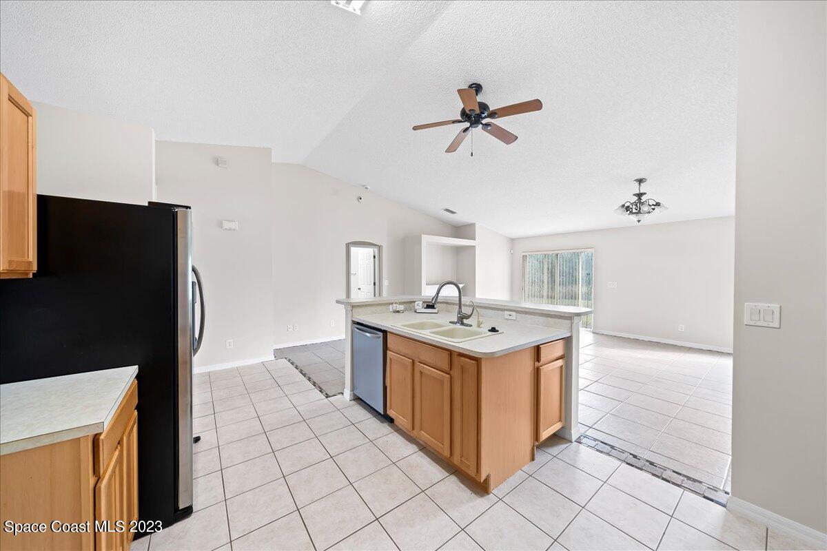 590 Fountain Street Southwest Palm Bay, FL 32908 - Photo 11 of 40 a view living room with a sink and a refrigerator