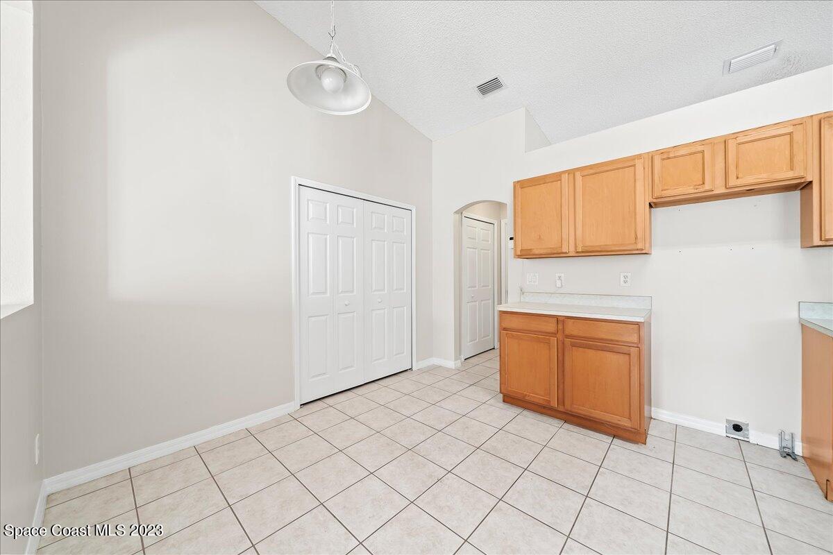 590 Fountain Street Southwest Palm Bay, FL 32908 - Photo 13 of 40 a view of an empty room with window and wooden floor