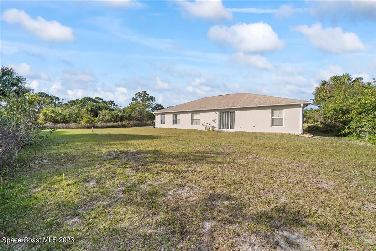 590 Fountain Street Southwest Palm Bay, FL 32908 - Photo 29 of 40 a view of a house with a yard and balcony