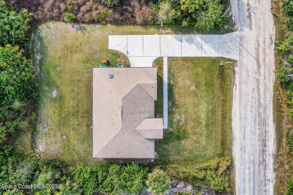 590 Fountain Street Southwest Palm Bay, FL 32908 - Photo 31 of 40 an aerial view of a house with outdoor space and a lake view