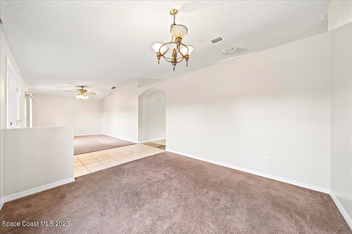 590 Fountain Street Southwest Palm Bay, FL 32908 - Photo 8 of 40 a view of a hallway with a chandelier