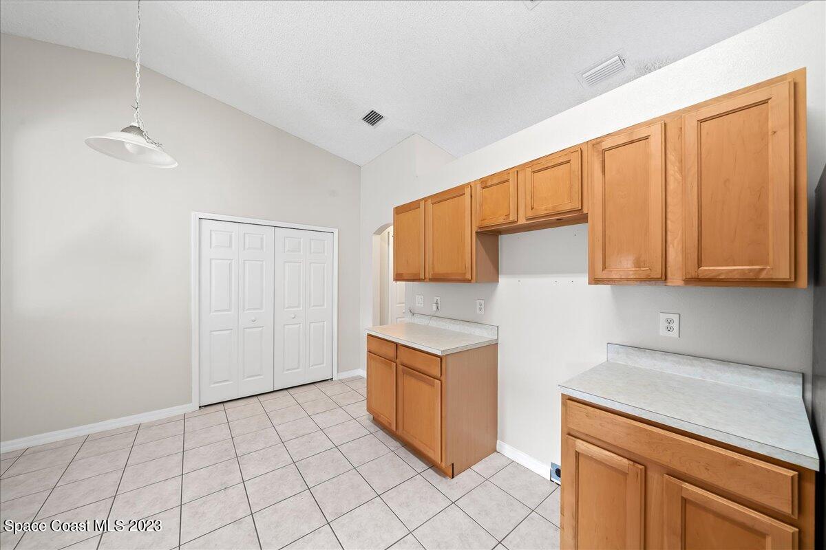 590 Fountain Street Southwest Palm Bay, FL 32908 - Photo 9 of 40 a kitchen with stainless steel appliances a sink stove and cabinets