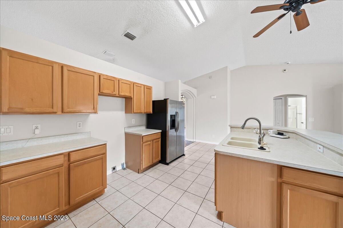 590 Fountain Street Southwest Palm Bay, FL 32908 - Photo 10 of 40 a kitchen with stainless steel appliances granite countertop a sink dishwasher stove refrigerator and cabinets