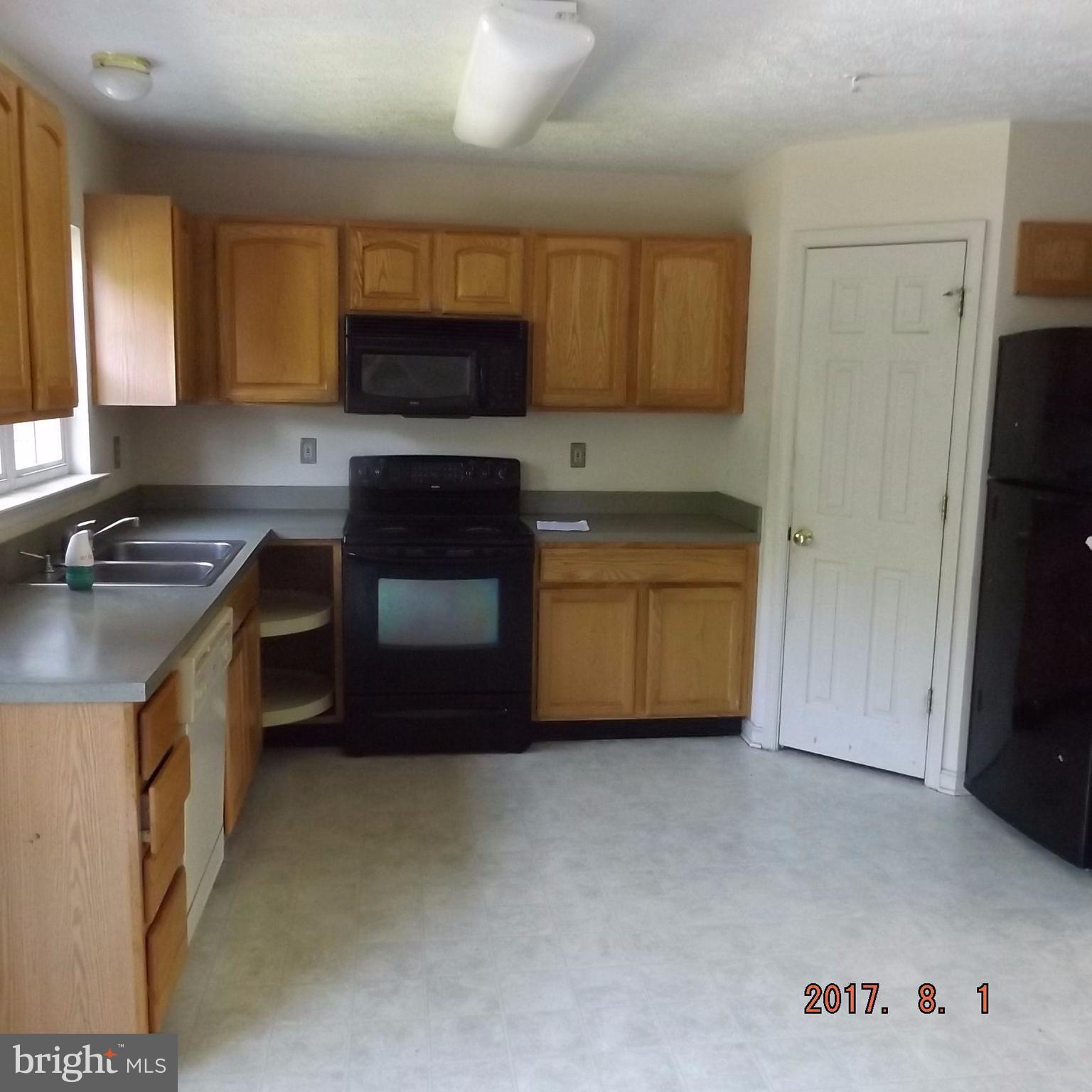 2450 Beaver Crossing Road Edgewood, MD 21040 - Photo 11 of 18 a kitchen with stainless steel appliances granite countertop a stove a sink and a refrigerator with wooden cabinets