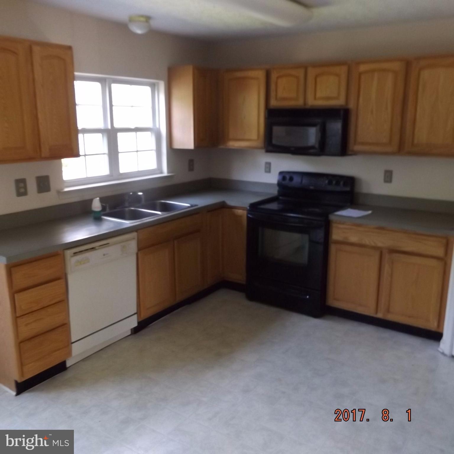 2450 Beaver Crossing Road Edgewood, MD 21040 - Photo 10 of 18 a kitchen with stainless steel appliances granite countertop a stove a sink and a microwave